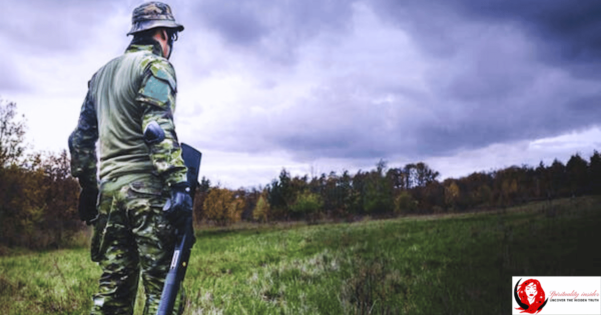 an armed person with a gun in open field