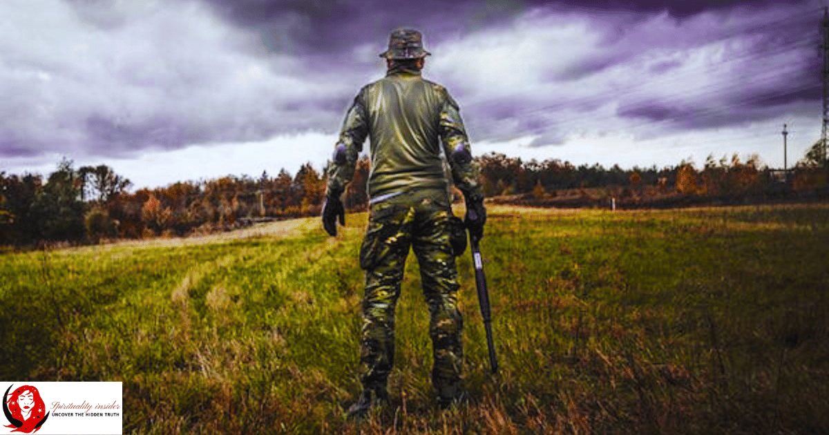 Army personal holding a gun in an open field
